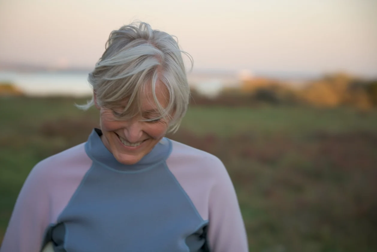 mature-woman-surfer-at-sunset